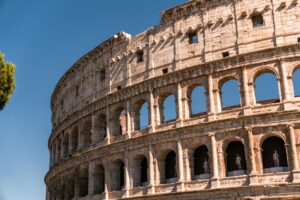 Leadership Lessons Students Can Learn From Rome 1 Close-up of the Colosseum in Rome under a clear blue sky, showcasing its ancient architectural grandeur.